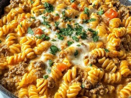 Stovetop creamy ground beef pasta in a large skillet with Parmesan cream sauce and freshly grated Parmesan on top