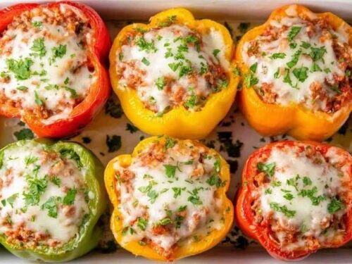 Easy stuffed peppers with ground beef and melted cheese in a baking dish
