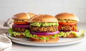 Homemade veggie burger recipe with quinoa patties served on a toasted bun with lettuce and tomato
