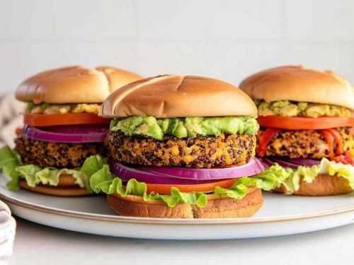 Homemade veggie burger recipe with quinoa patties served on a toasted bun with lettuce and tomato