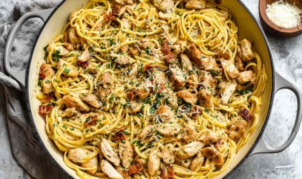 Creamy Chicken Carbonara with spaghetti, crispy bacon, and sliced chicken tenders in a skillet