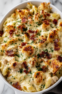 Crazy Good Casserole baked in a 9x13 dish with golden melted cheddar cheese and crumbled bacon on top