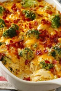 Easy low carb chicken casserole with golden melted cheddar and mozzarella fresh out of the oven in a 9x13 baking dish