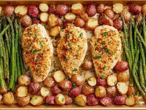 Parmesan Crusted Chicken Sheet Pan Dinner with golden chicken breasts, roasted red potatoes, and green beans on a sheet pan