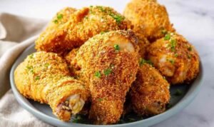 Crispy homemade shake and bake chicken thighs and drumsticks on a wire rack fresh out of the oven